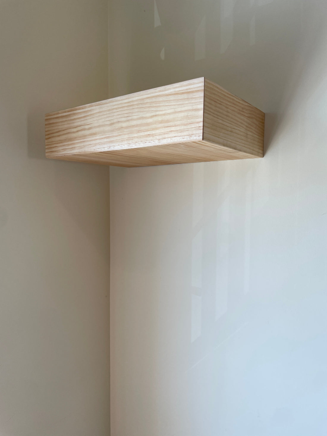 Minimalist natural pine floating wall shelf with a hidden compartment by Beetle Wood, a clean piece with no visible lock or handle