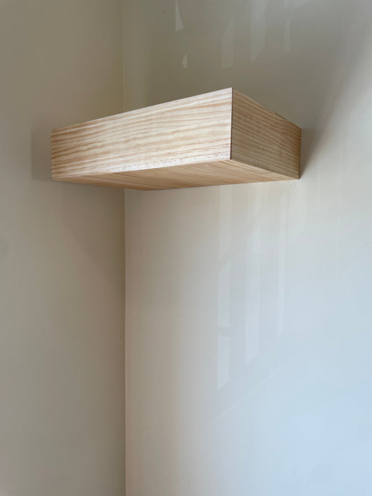 Minimalist natural pine floating wall shelf with a hidden compartment by Beetle Wood, a clean piece with no visible lock or handle